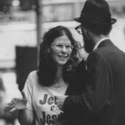 70's picture of a young Jewish woman believer in Jesus talking to a Jewish man