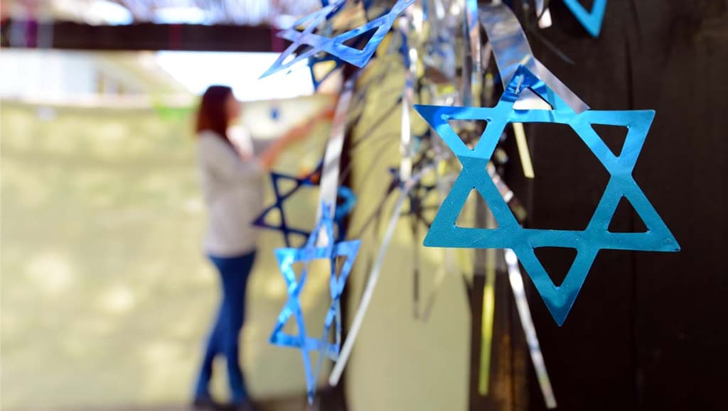 Woman decorating a sukkah