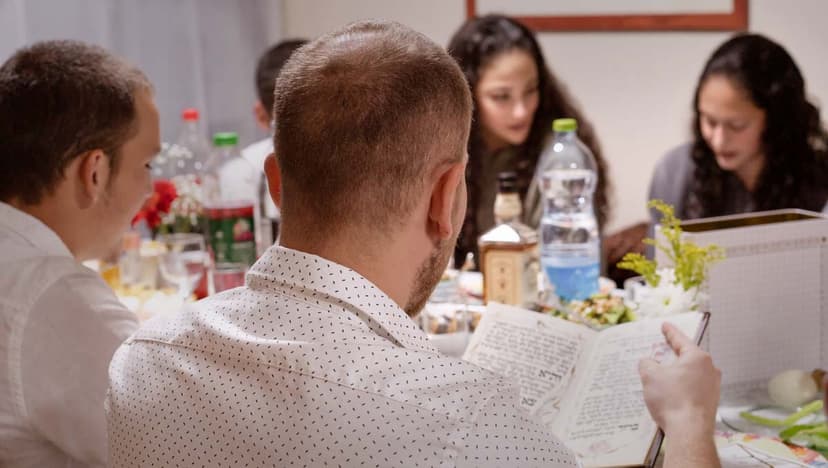 Family celebrating Passover with Haggadah