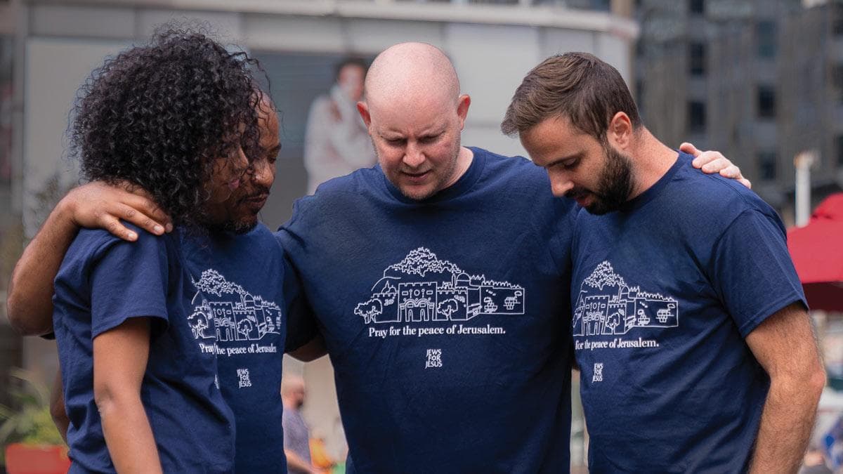 Group of Messianic believers praying outdoors