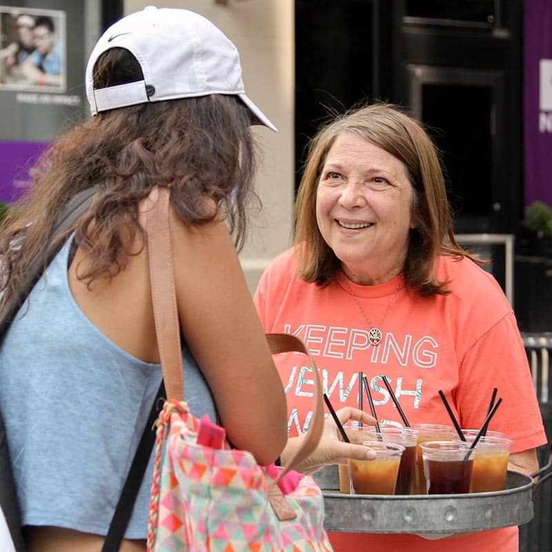 Susan Perlman talking with a young woman in NY