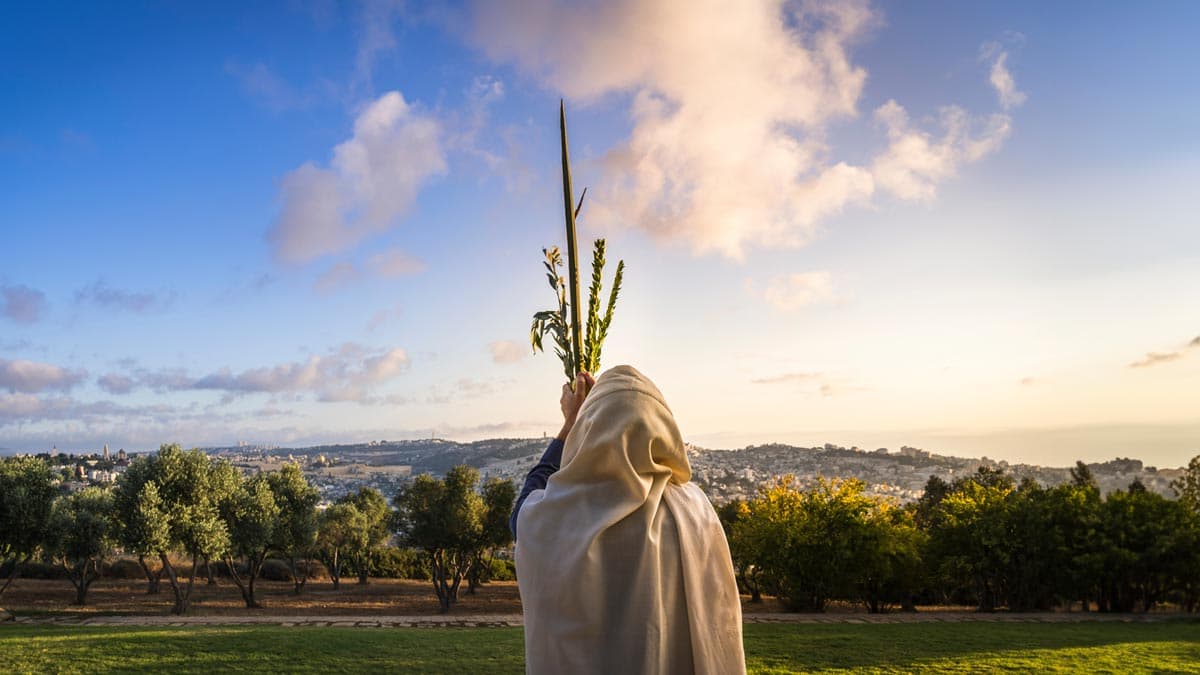 Jewish man holding lulav and etrog