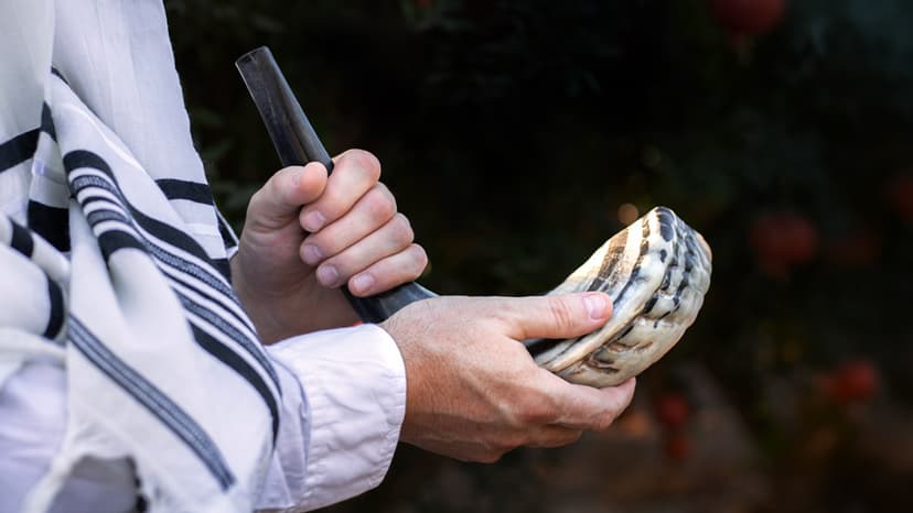 Close-up of a man's hand holding a shofar.