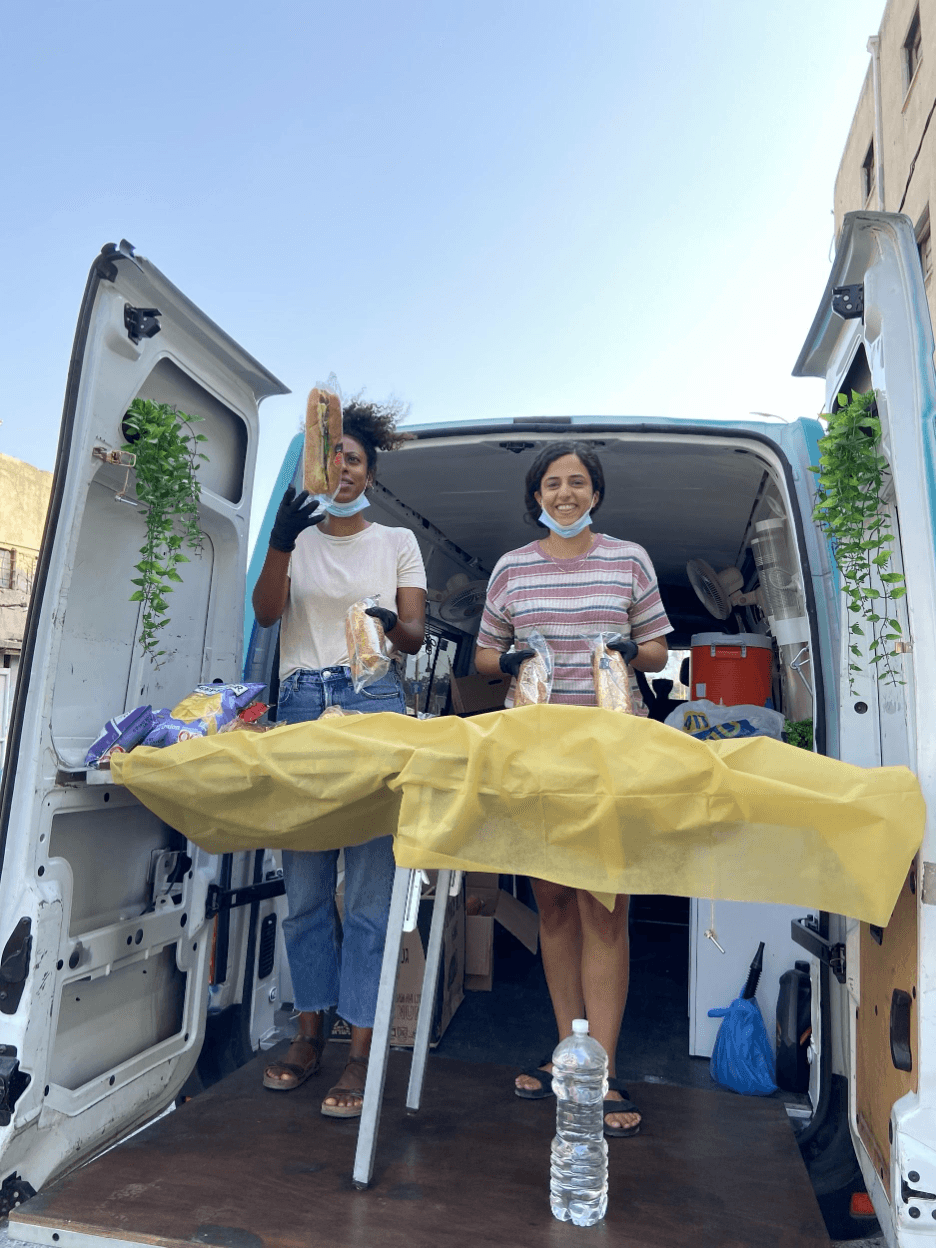 Danielle serves sandwiches from the back of the truck.