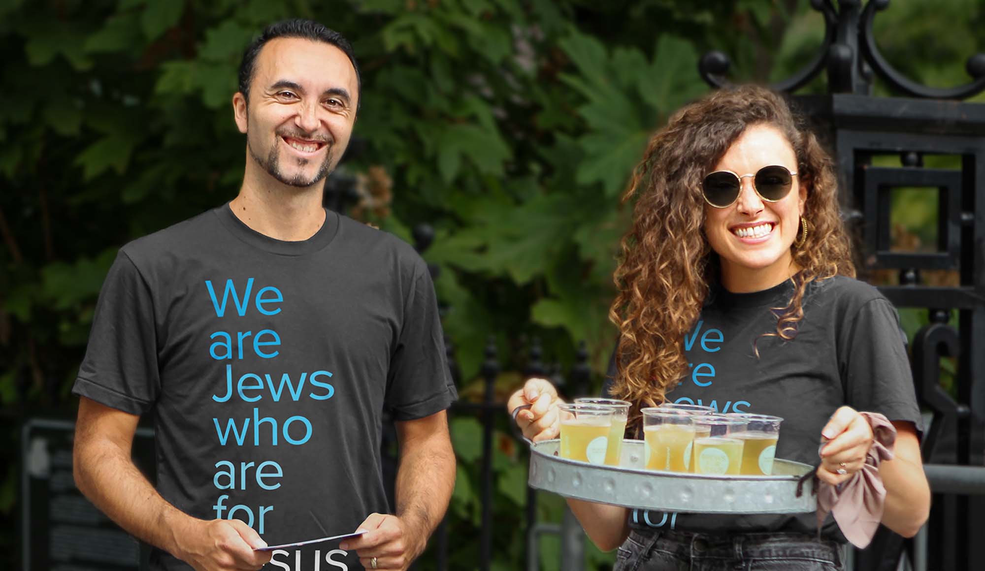 Smiling woman and man offering cold drinks