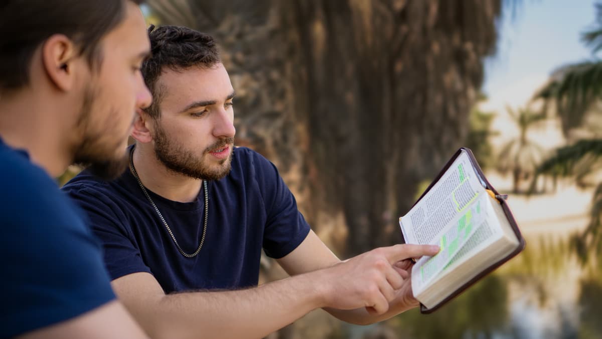 Young man sharing Scripture with his friend