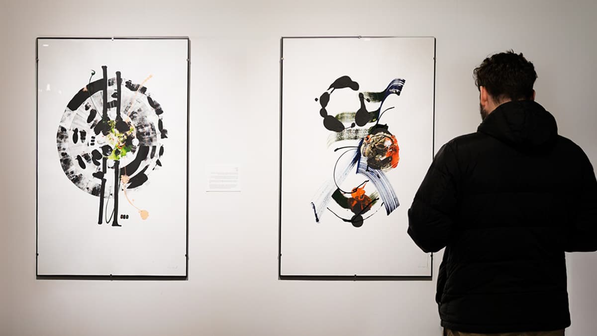 Visitor views an artwork from Questions for God show