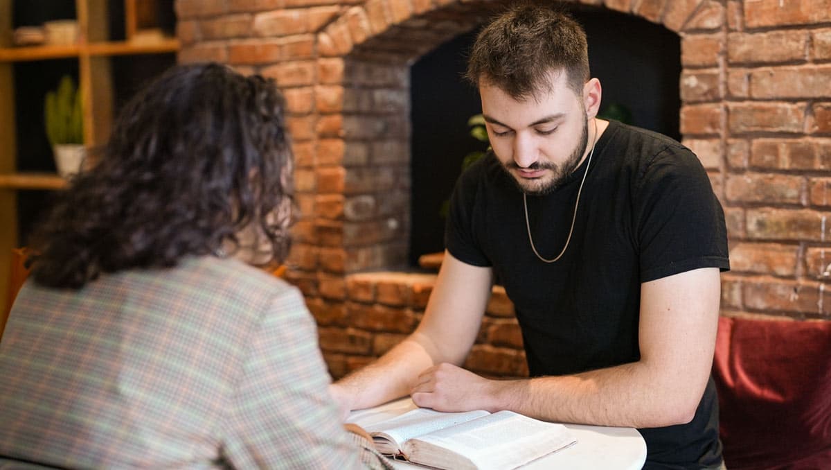 Young man and woman studying the Bible
