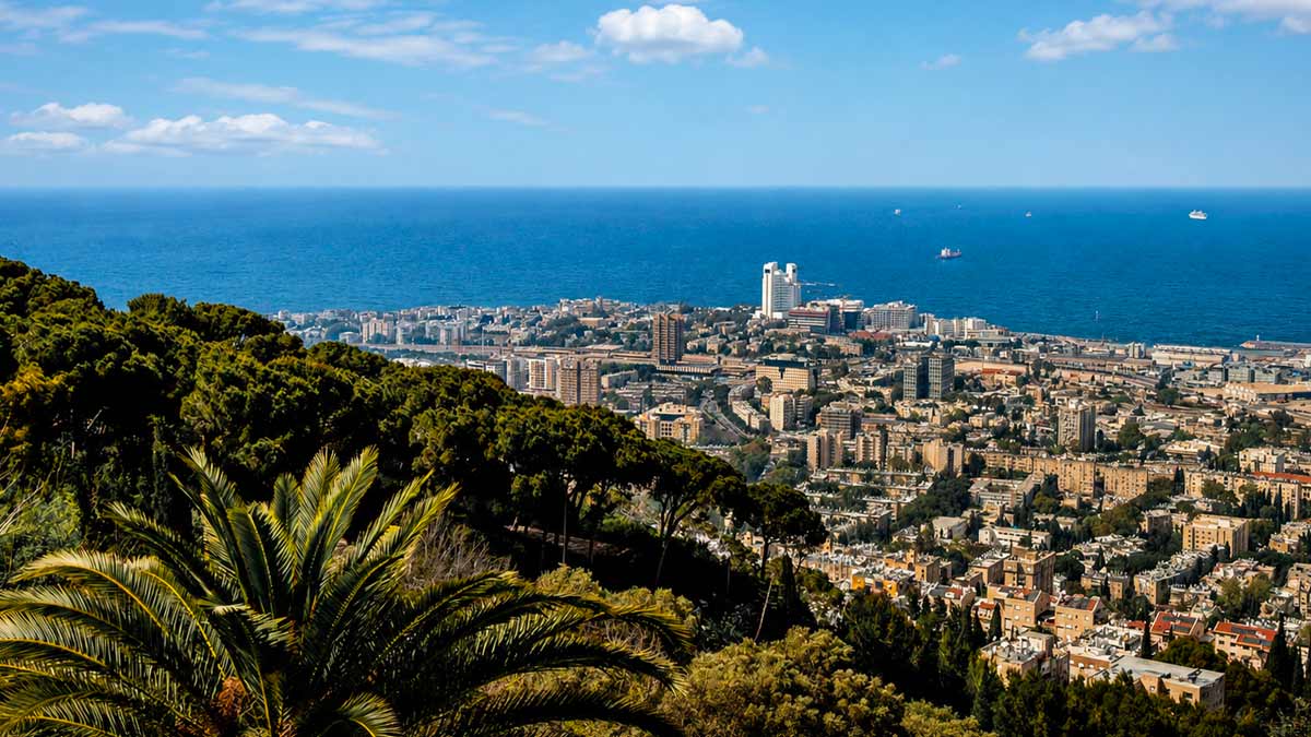 Panoramic view of Haifa, Israel, overlooking the city, Mediterranean Sea, green hills, palm trees, and coastal skyline.