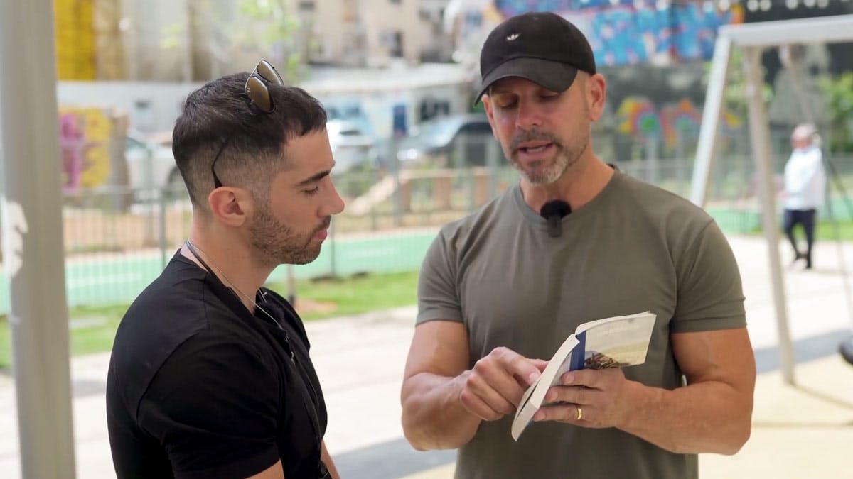 Jeff Morgan shares a New Testament Scripture with an Israeli man on the street after an interview with him.