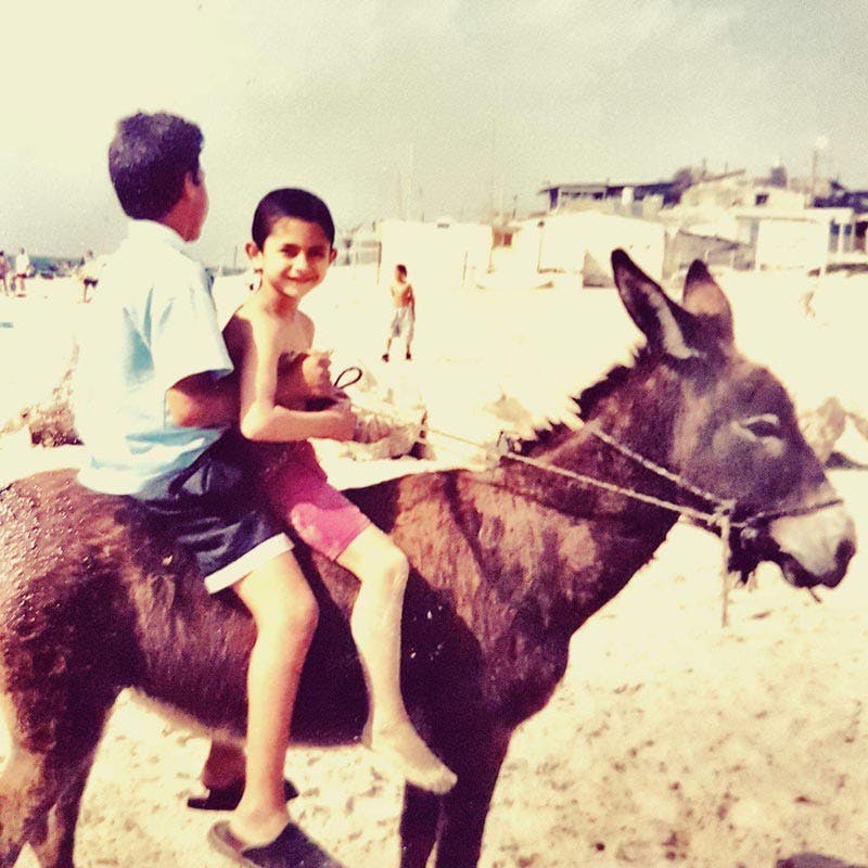 Sahar with brother riding a donkey