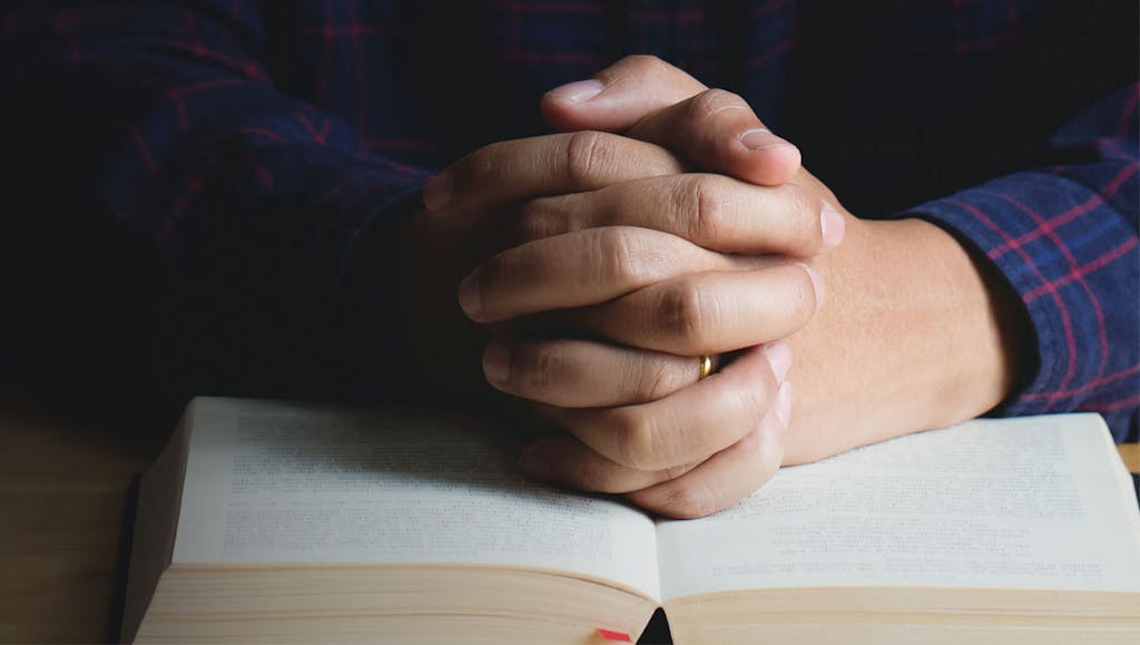 Man prays thanksgiving with the Bible